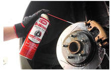 CRC Brakleen brake parts cleaner spray can held near a brake rotor with gloves