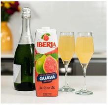 Iberia guava nectar carton beside two glasses of yellow guava drink