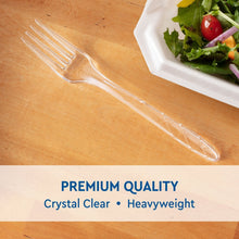 Clear plastic fork, full length, on wooden table