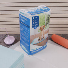 Dog training pads pack on a table with visible blue absorbent pad sheets