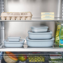 Light blue rectangular food storage containers in a refrigerator shelf lineup