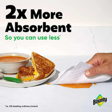 Absorbent white paper towel wiping up spilled liquid