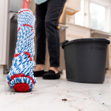 MicroTwist MAX microfiber mop head and red handle on floor beside cleaning bucket