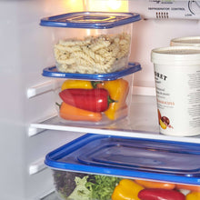 Stacked square food storage containers with clear plastic bodies and blue snap lids