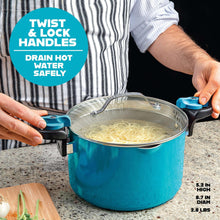 Aqua blue pasta pot with glass lid and twist-lock handles, boiling noodles being strained