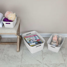 Three white plastic storage bins with side carry handles for organizing items