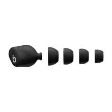 Single dark wireless earbud with silicone tip and short stem, side profile