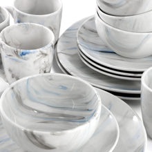 Marble-style porcelain bowls and mugs with blue accents in a stacked set