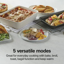 Countertop toaster oven with open door and wire rack, with multiple prepared dishes