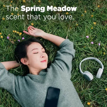 Spring Meadow scent with person resting outdoors wearing headphones