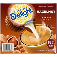 Hazelnut coffee creamer singles box with 192 count and serving suggestion pour