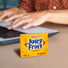Juicy Fruit Original gum pack on a tabletop near a laptop