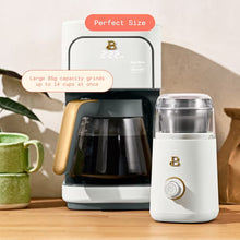 White electric blade coffee grinder beside a drip coffee maker