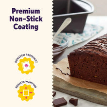 Non-stick brownie pan with dark baking surface next to sliced cake and brownies