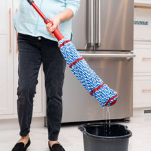 Microfiber mop on red handle with long blue-and-white braided head over dark bucket