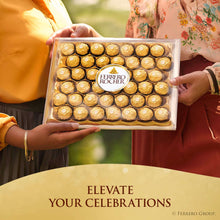 Ferrero Rocher chocolate box held by hands with round gold-wrapped chocolates