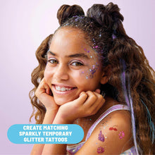 Child with glitter face sparkles and purple temporary glitter tattoos, smiling