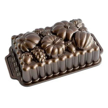 Bronze-toned metal bundt loaf pan with scalloped and floral relief