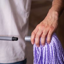 Lavender microfiber mop head refill being fitted onto mop handle connector