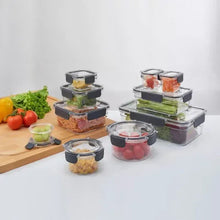 Tritan food storage set of clear containers with black lids, assorted prepared foods shown