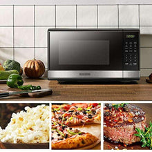 Black stainless microwave oven with open door and cooking cavity window