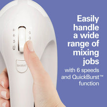 White electric hand mixer body with speed dial and a hand adjusting the setting
