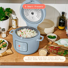 Cornflower blue electric rice cooker with open lid and serving bowls set nearby