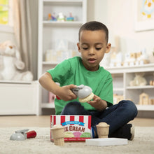 Ice cream play set with wooden cones and scoop on playtable, used by a child