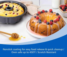 Round fluted cake pan holding a decorated bundt-style cake.