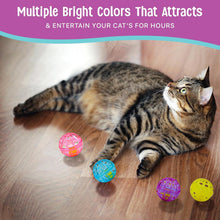Tabby cat lying beside scattered multicolor lattice bell balls on hardwood