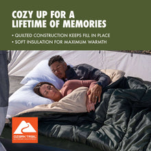 Doublewide sleeping bag with light quilted layer and dark cover, shown on beds