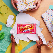 Starburst Jellybeans candy bag with FaveReds branding among wrapped gift items
