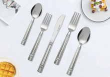 Stainless steel flatware set with fork, spoon, and knife featuring patterned handles