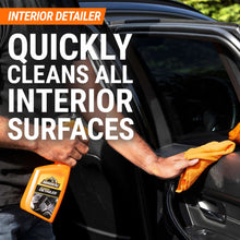 Interior detailer spray bottle and cloth wiping a car dashboard