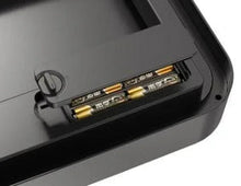 Side of black automatic trash can showing exposed internal sensor/battery contacts