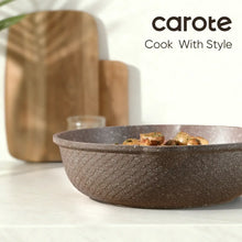 Brown speckled nonstick deep pan with wood handles, filled with food