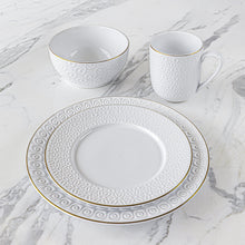 White stoneware bowls with embossed swirl texture and gold rim