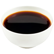 Small white bowl filled with dark vanilla liquid
