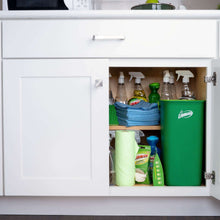 Green mop bucket and microfiber pads stored in kitchen cabinet