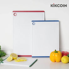 Three large plastic cutting boards with multicolor borders and hanging hole handles
