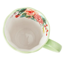 Ceramic mug interior with floral rose rim and mint handle