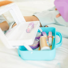 Blue makeup organizer filled with pretend compacts, brushes, and colorful tubes and bottles.