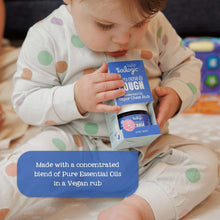 Baby holding Oilogic vapor chest rub box while seated on couch