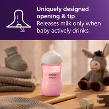 Pink Philips Avent Natural baby bottle on table, white nipple, child-feeding