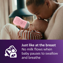 Pink Philips Avent Natural baby bottle feeding baby, white nipple and cap