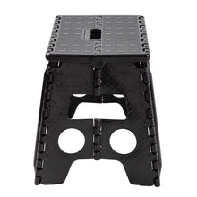 Black plastic folding step stool with molded grips and circular safety openings