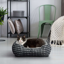Diamond-pattern plush pet bed with gray interior and raised rim, with cat inside