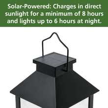Black solar lantern with flat solar panel on top, glass sides, candle cylinder inside.