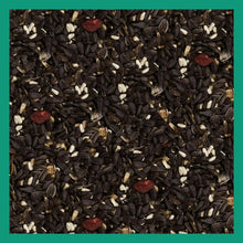 Wild bird seed mix filling the bag, dark sunflower and striped seeds