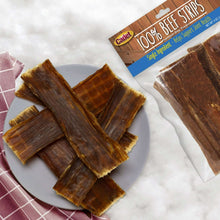 Brown beef jerky treat strips on a plate, single-ingredient dog chews
